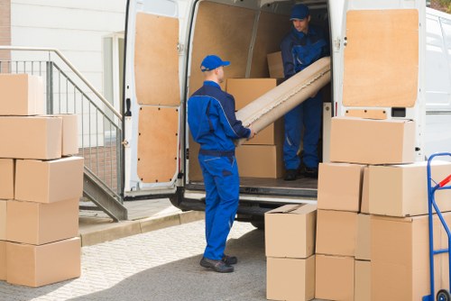 Removal company vehicle and moving team preparing for a home move in Hatton
