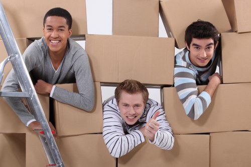 Removal team carrying furniture through a Hatton property